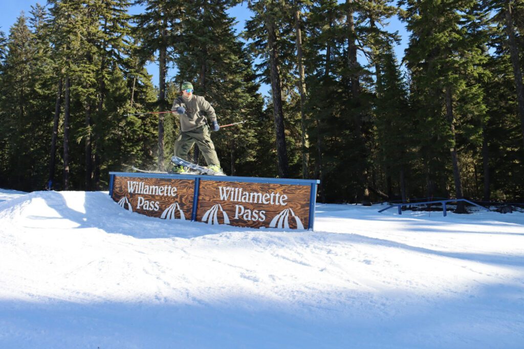 A skier rides a rail in a terrain park at Willamette Pass in Oregon