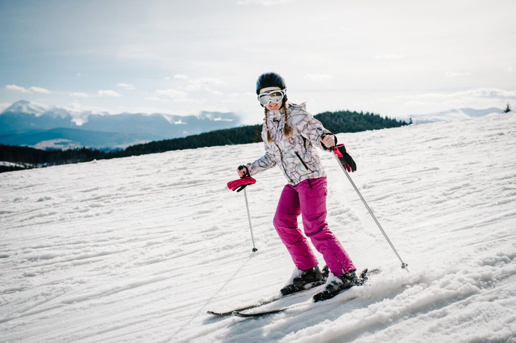 A woman skis on corn snow.