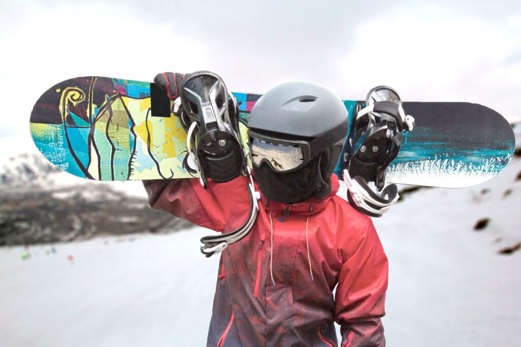 A snowboarder shows off his gear.