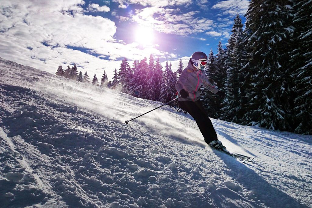 A woman skis down a mountain