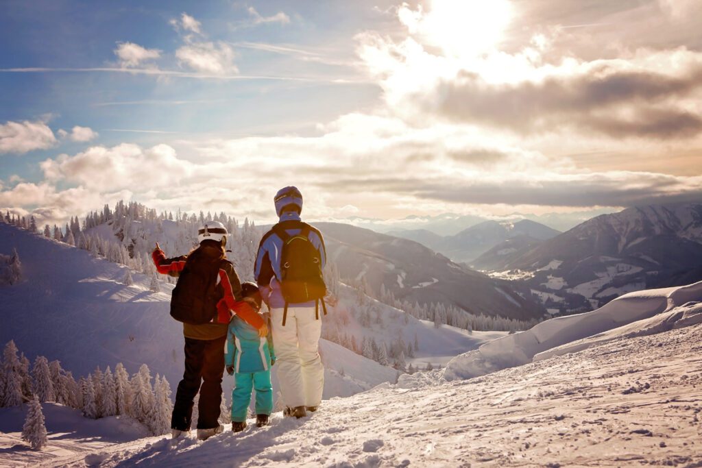 A family enjoys the ski view when staying at their ski vacation lodging