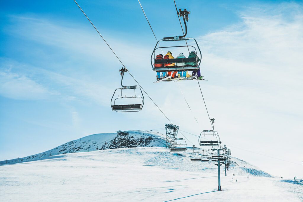 A family rides a ski lift.