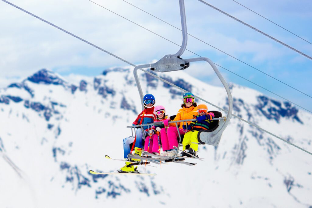 A family rides a ski lift