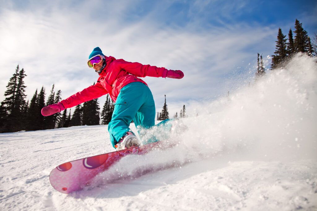 A snowboarder rips a slope because she has worked to stay in shape for skiing