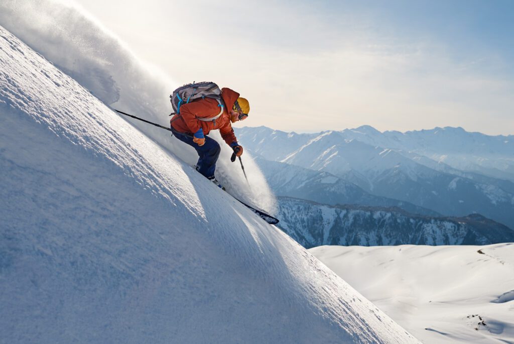 A skier attempts a double black slope because he stay in shape for skiing