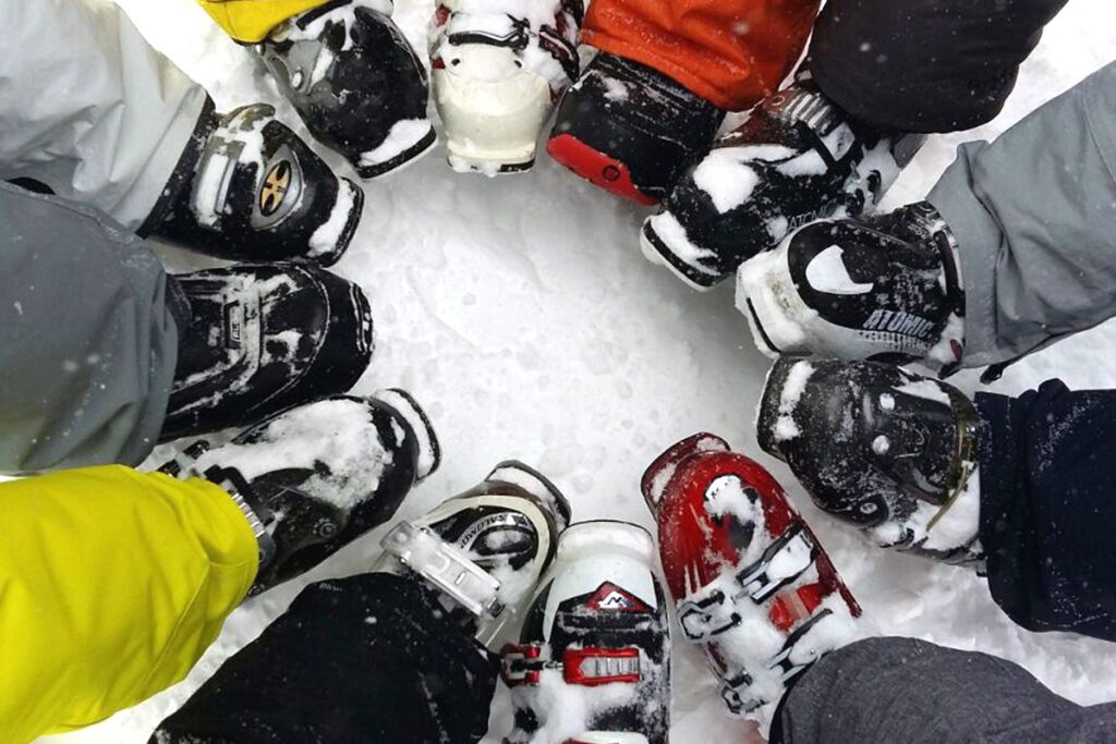 A circle of ski boots in the snow