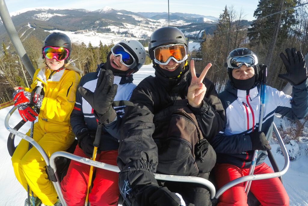 A family rides a ski lift