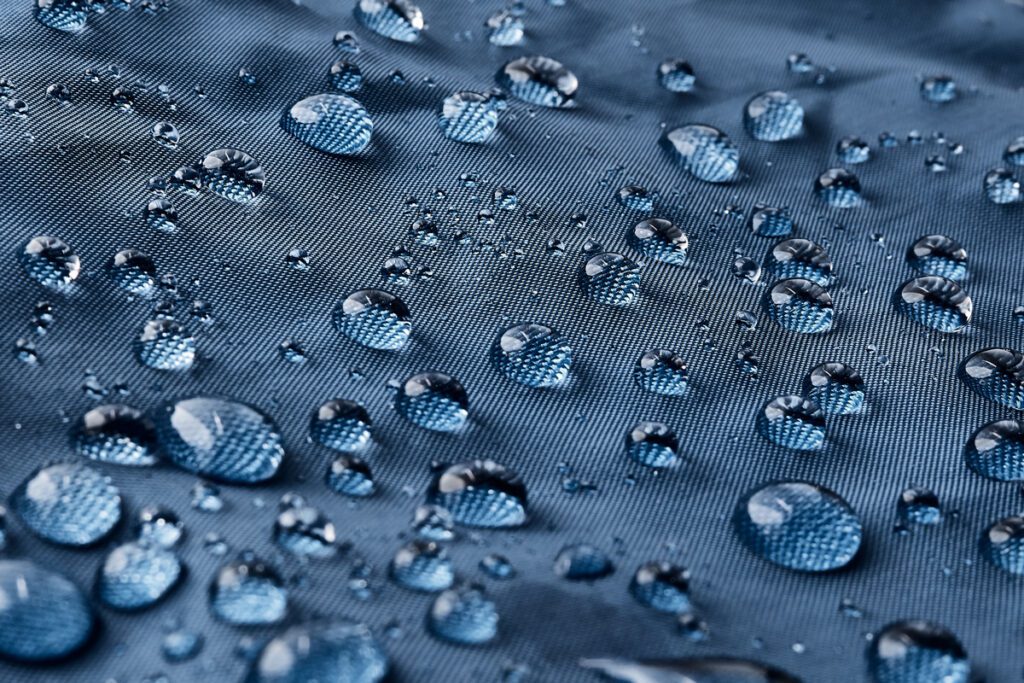 Water beads up on a cloth surface