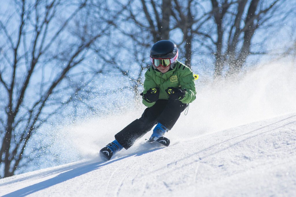 A young man skis down a mountain