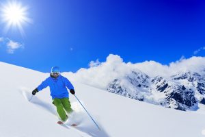 bowl-skiing-powder-blue-sky-green-pants-blue-jacket