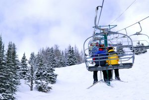 skiers-riding-the-chair-back-view