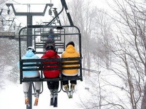 3-skiers-on-a-chair-lift-snowy-day