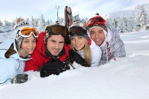 friends-lying-in-snow-smiling