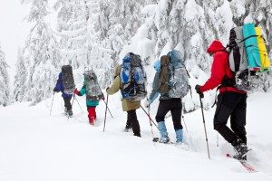 group-hiking-backpacks-snowing