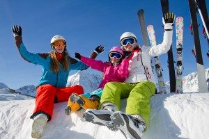 mom-with-two-girls-arms-up-smiling-sitting