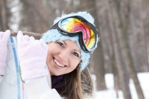 shutterstock_49224631_Happy smiling woman with snowboard