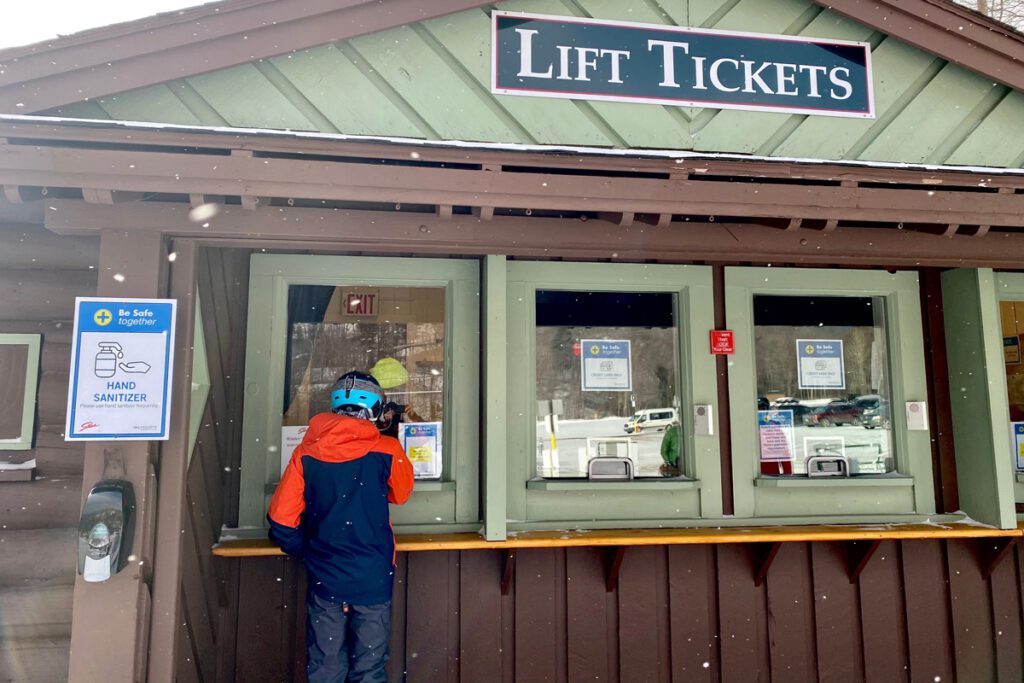 A skier buys a lift ticket at Stowe Vermont.