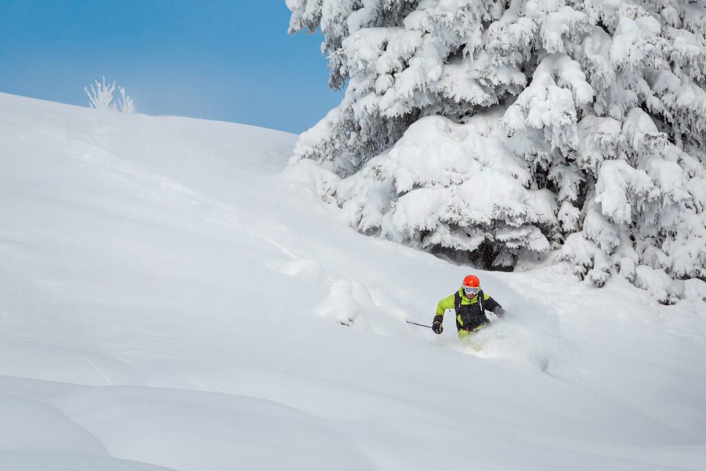 A man skis a powder run in Alaska