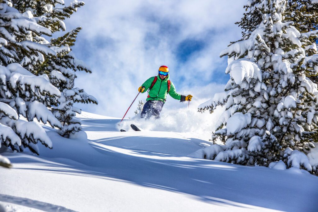 A skier navigates a powder run.