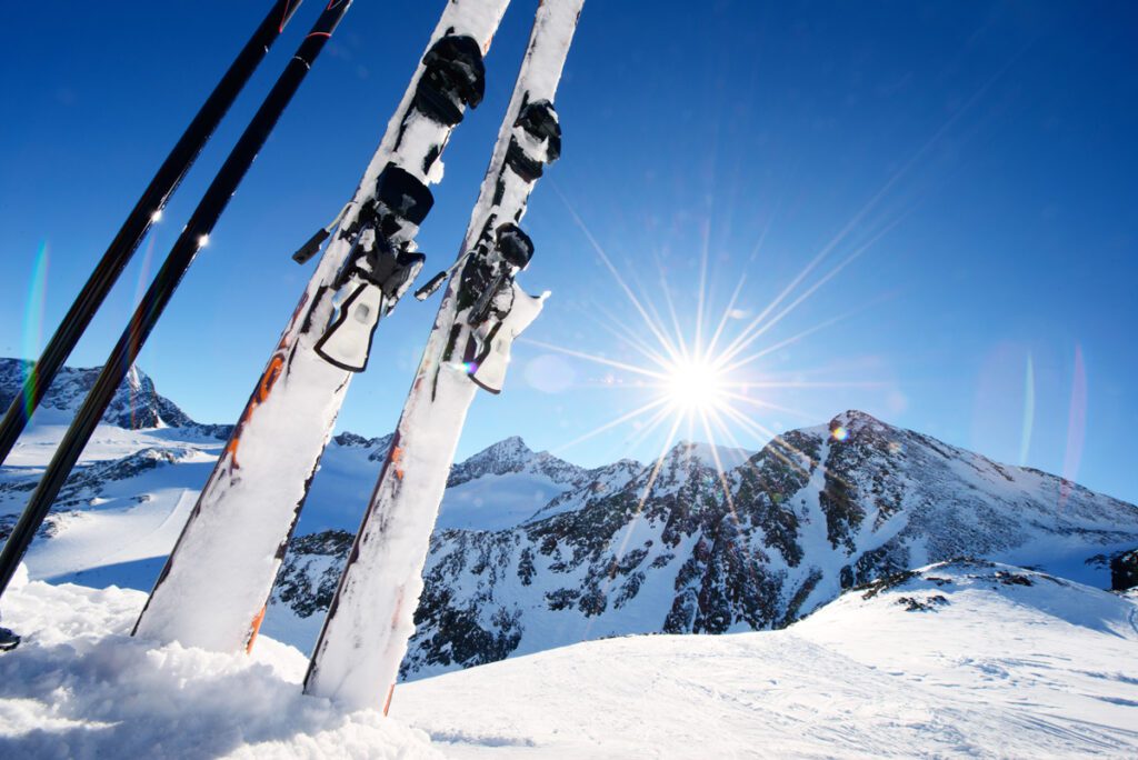 Skis stuck in the snow on a mountaintop