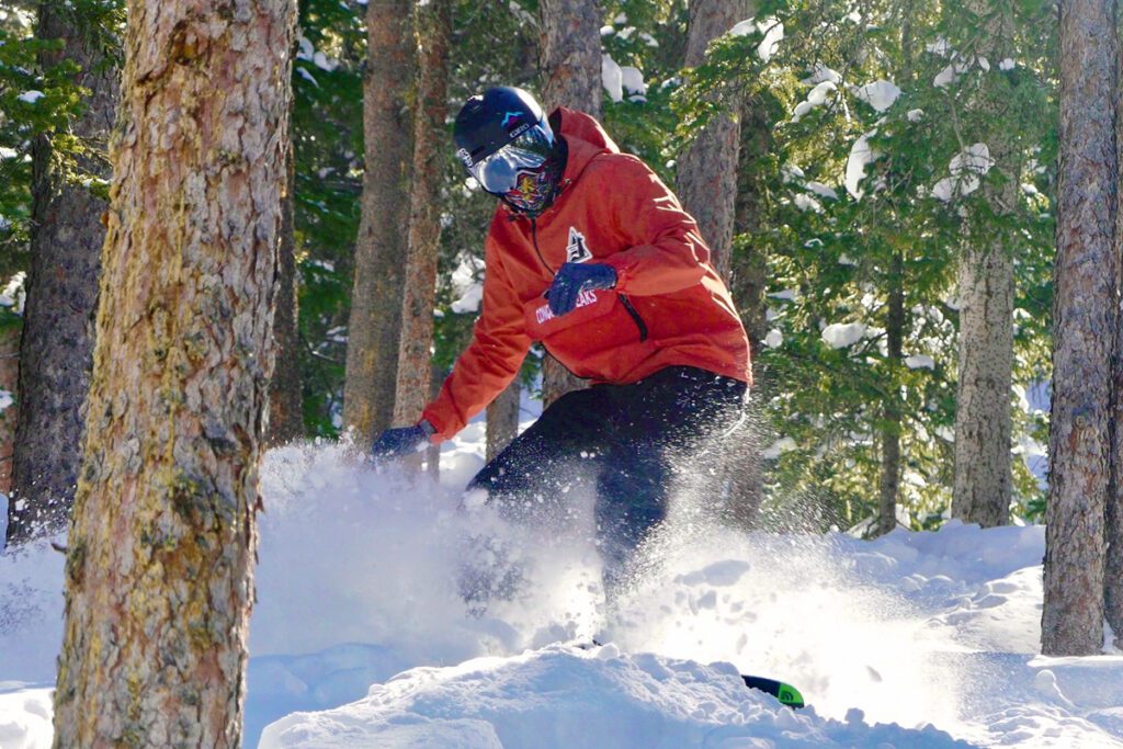 A man skis a tree run