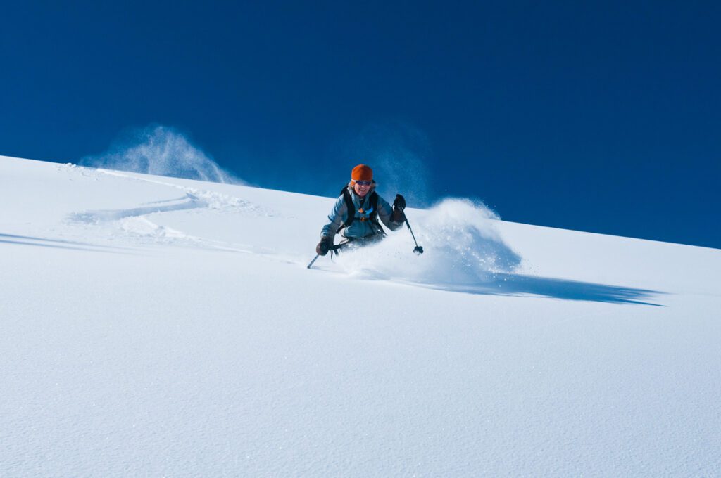 A skier cuts a fresh line in the backcountry