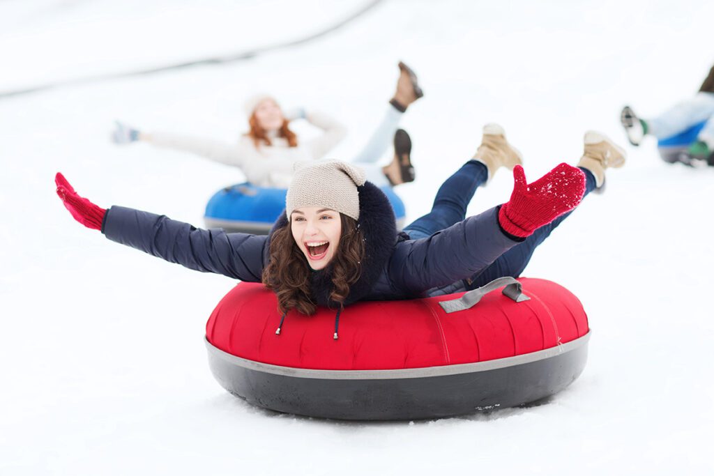 woman rides a snow tube